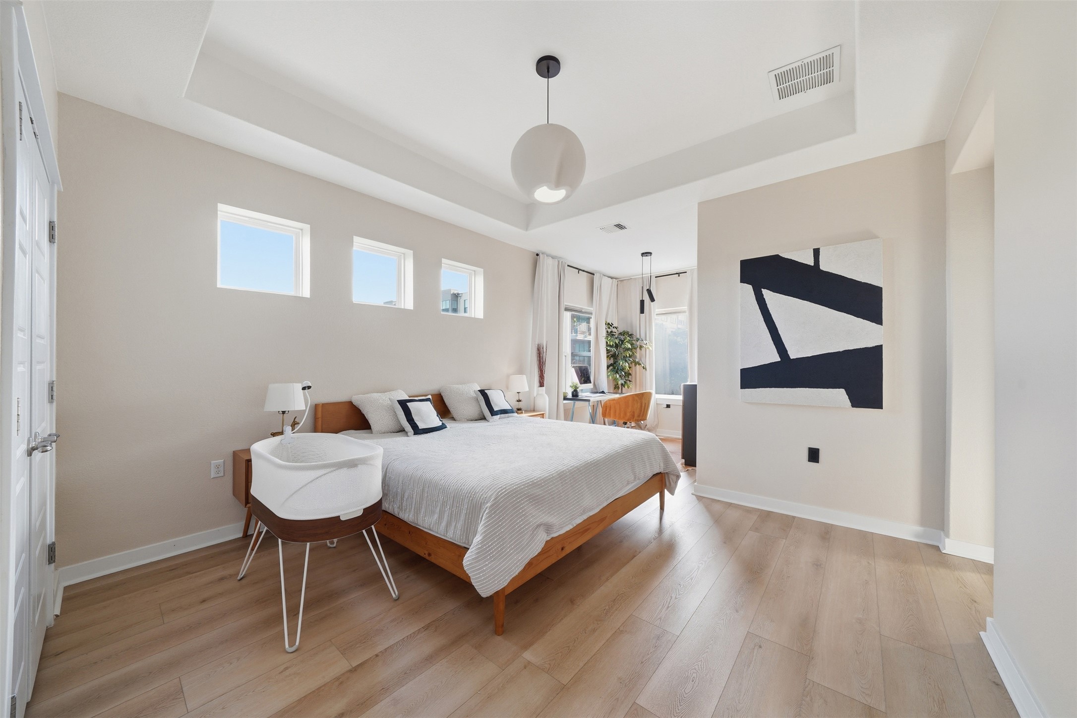 3901 Vaughan Street Austin, TX 78723 - Photo 19 of 37 Spacious bedroom featuring light wood-finish flooring, a tray ceiling, and recessed lighting