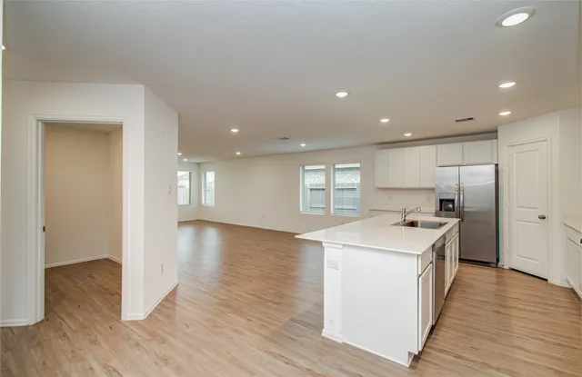 a kitchen with stainless steel appliances granite countertop a sink stove and microwave