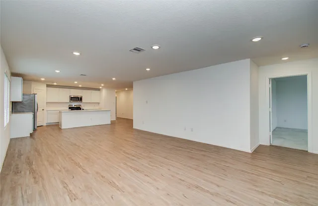 a view of kitchen with kitchen island and wooden floor