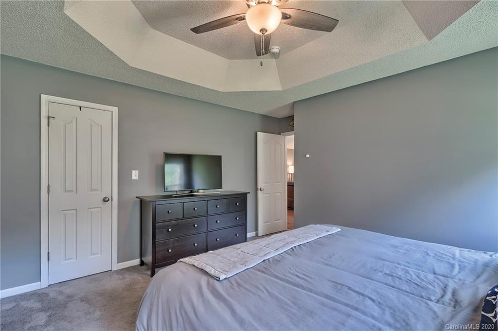 13314 Philip Michael Road Huntersville, NC 28078 - Photo 16 of 39 a bedroom with a bed and a dresser