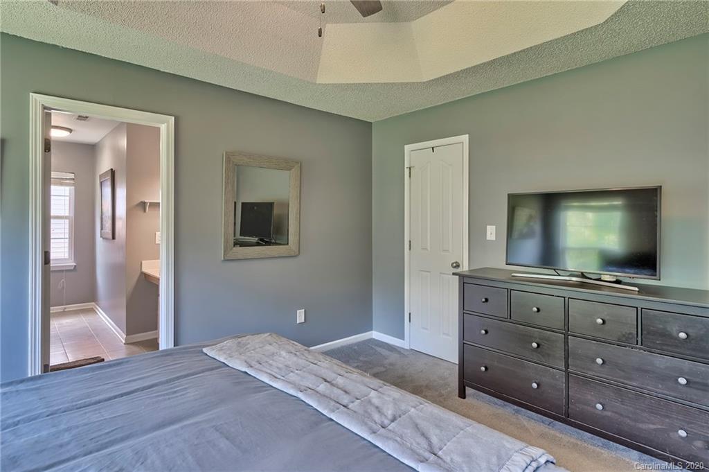 13314 Philip Michael Road Huntersville, NC 28078 - Photo 17 of 39 a bedroom with a bed and a flat screen tv