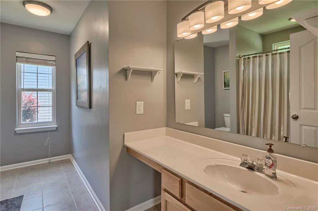 13314 Philip Michael Road Huntersville, NC 28078 - Photo 18 of 39 a bathroom with a sink vanity granite and a mirror