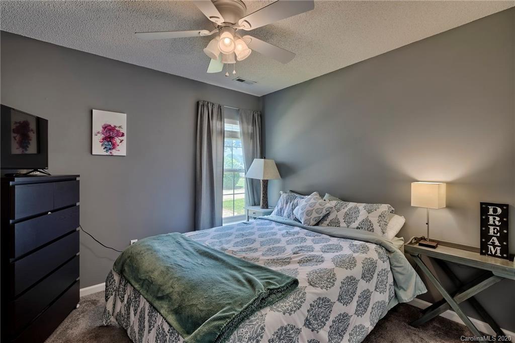 13314 Philip Michael Road Huntersville, NC 28078 - Photo 20 of 39 a bedroom with a bed and a chandelier
