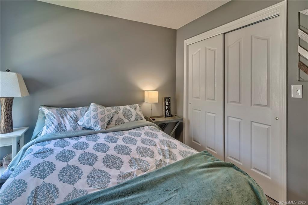 13314 Philip Michael Road Huntersville, NC 28078 - Photo 21 of 39 a bedroom with a large bed and a wooden floor