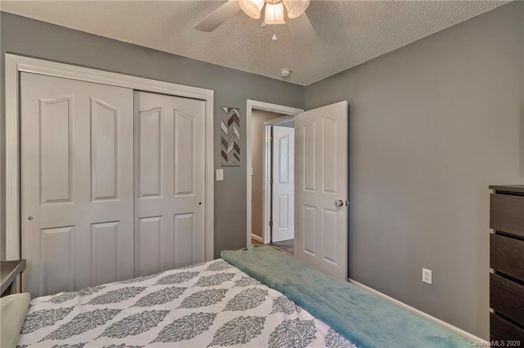13314 Philip Michael Road Huntersville, NC 28078 - Photo 23 of 39 a bedroom with a bed and a chandelier fan