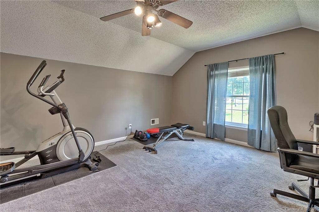 13314 Philip Michael Road Huntersville, NC 28078 - Photo 30 of 39 a view of a room with gym equipment