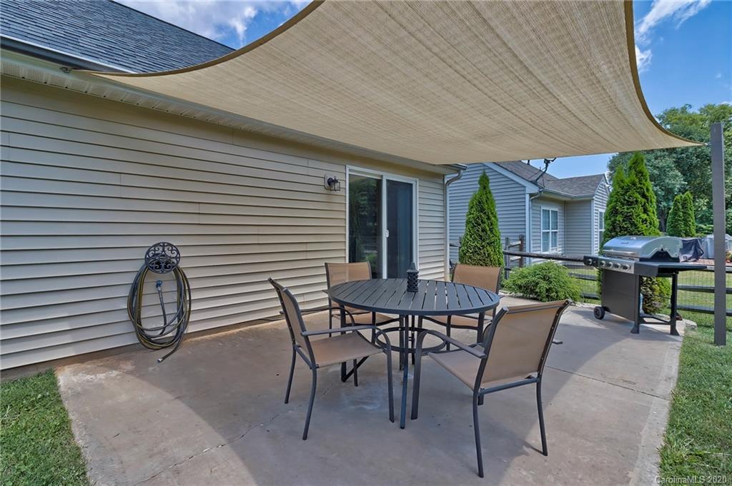 13314 Philip Michael Road Huntersville, NC 28078 - Photo 33 of 39 a view of a patio with table and chairs and potted plants