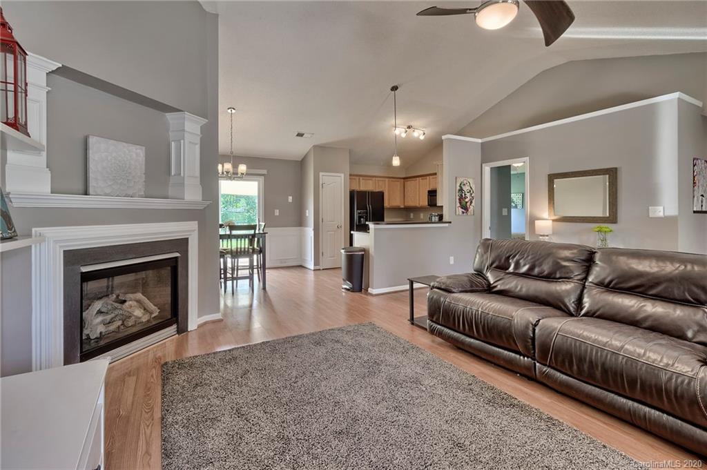 13314 Philip Michael Road Huntersville, NC 28078 - Photo 6 of 39 a living room with furniture and a fireplace