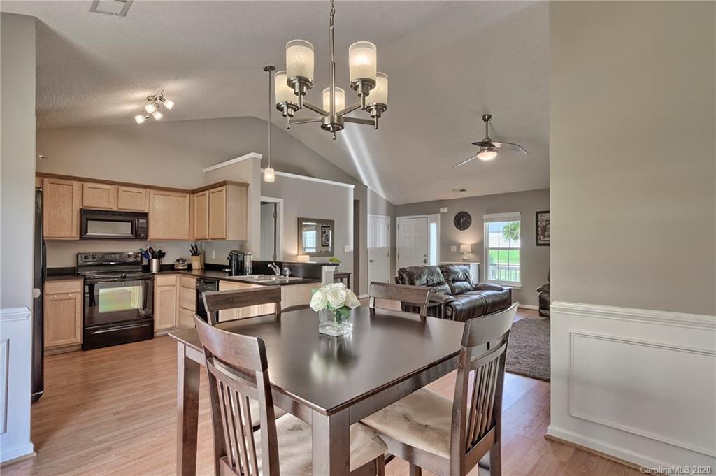 13314 Philip Michael Road Huntersville, NC 28078 - Photo 7 of 39 a view of a dining room with furniture and wooden floor