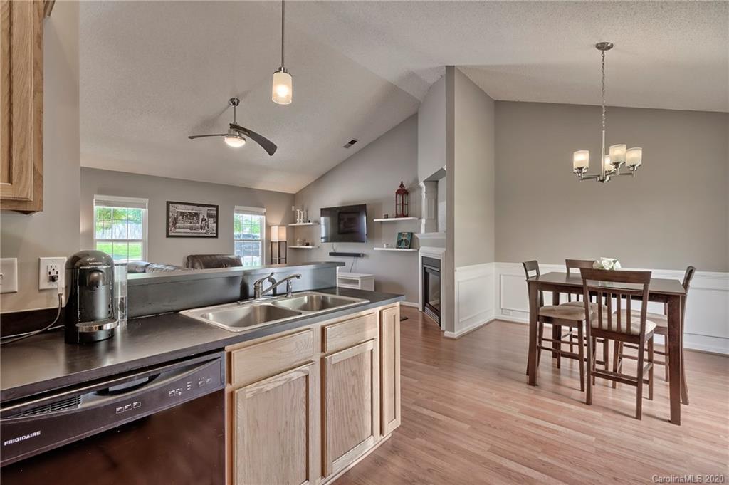 13314 Philip Michael Road Huntersville, NC 28078 - Photo 9 of 39 a kitchen with stainless steel appliances a table chairs and chandelier