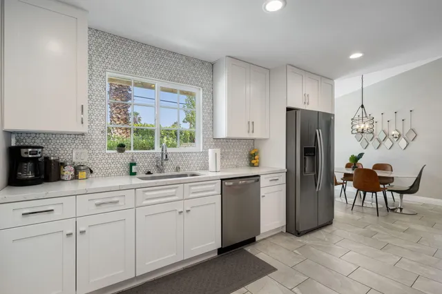 a kitchen with stainless steel appliances a refrigerator sink and cabinets