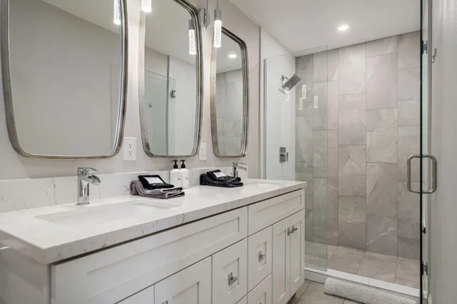 a bathroom with double sink and a mirror