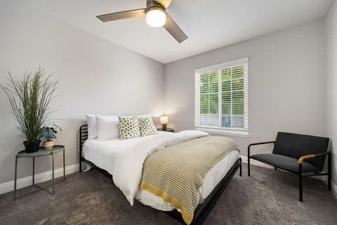 a bedroom with bed and a window