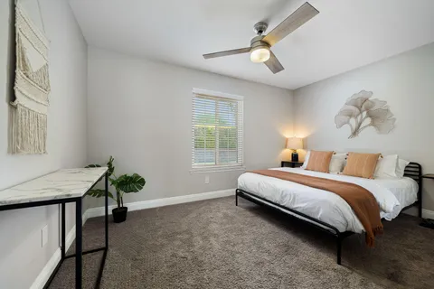 a spacious bedroom with a bed and a window