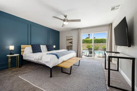 a bedroom with a bed and large window