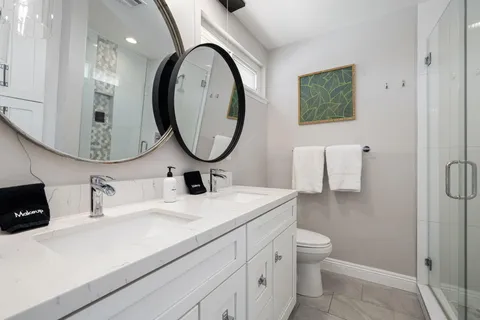 a bathroom with a toilet a sink and a mirror