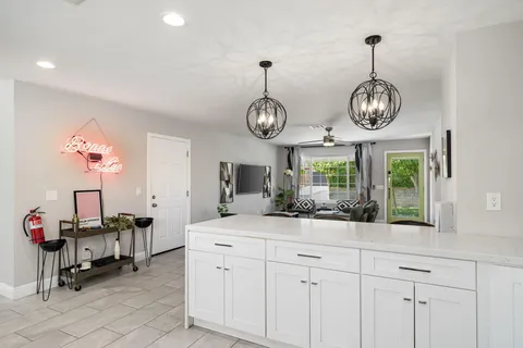 a view of dining room and hall with a chandelier