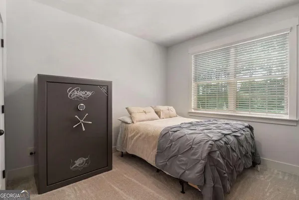 a bed sitting in a bedroom next to a window