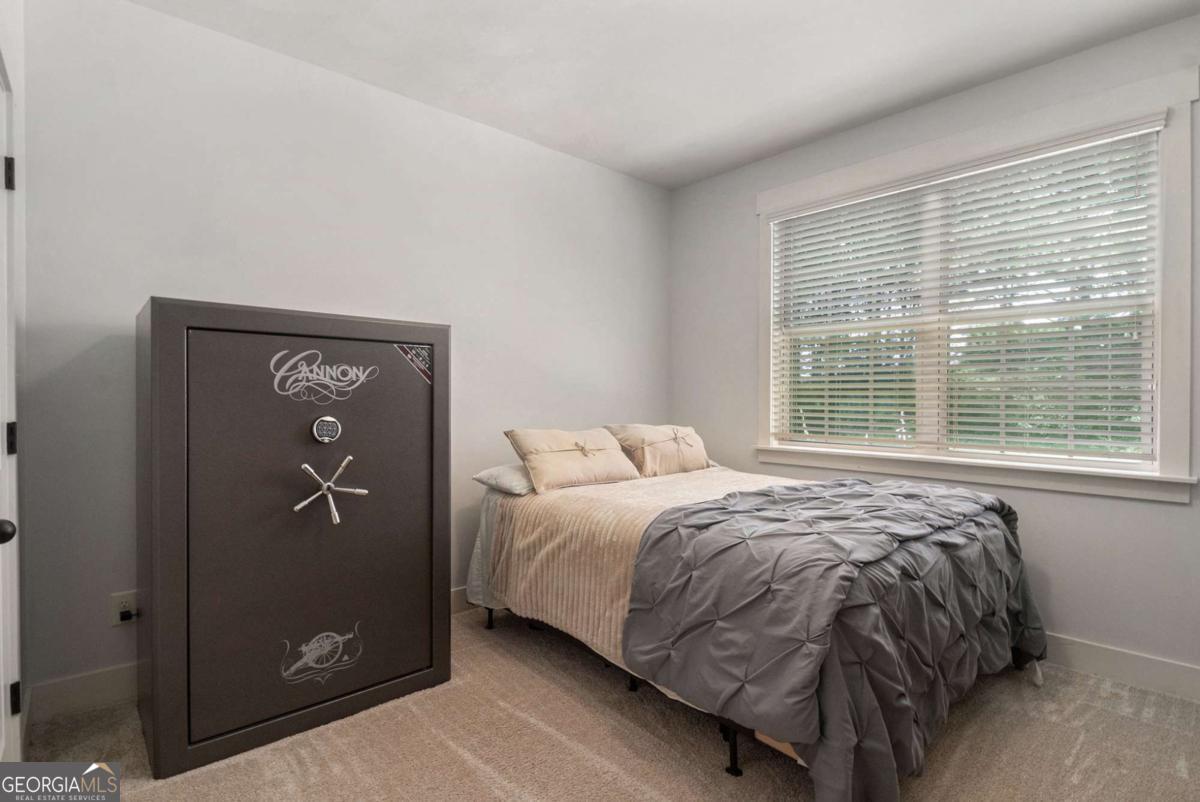 466 Austin Storey Circle Newnan, GA 30263 - Photo 15 of 39 a bed sitting in a bedroom next to a window