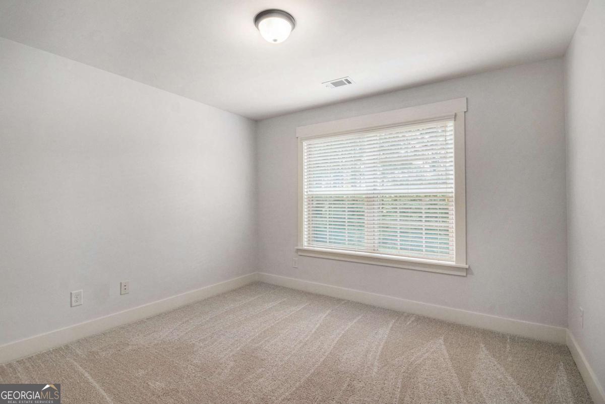 466 Austin Storey Circle Newnan, GA 30263 - Photo 16 of 39 an empty room with a window