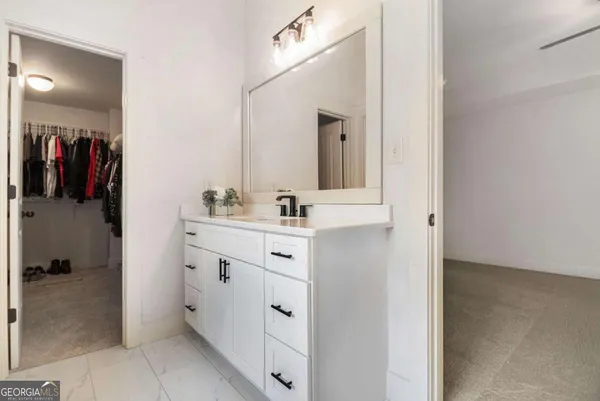 a bathroom with a sink vanity and a mirror