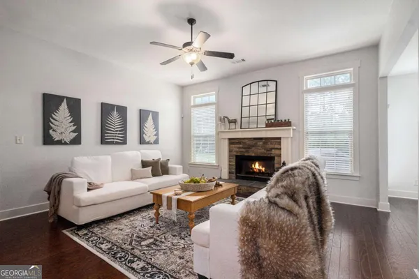 a living room with furniture and a fireplace