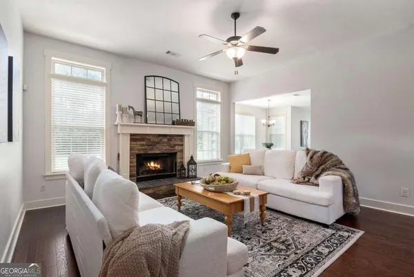 a living room with furniture a chandelier and a fireplace