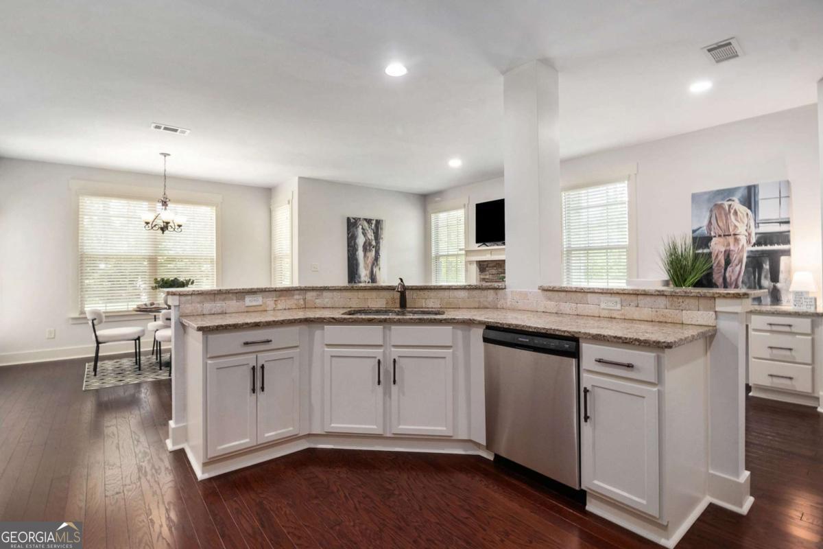 466 Austin Storey Circle Newnan, GA 30263 - Photo 5 of 39 a kitchen with a sink cabinets and wooden floor