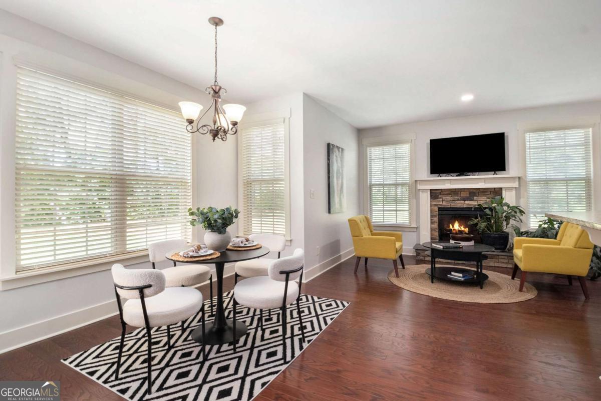 466 Austin Storey Circle Newnan, GA 30263 - Photo 7 of 39 a view of a dining room with furniture window and wooden floor