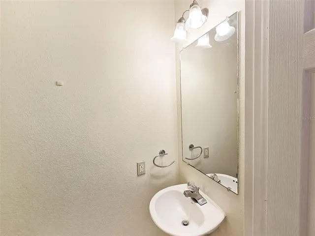 a bathroom with a sink and mirror