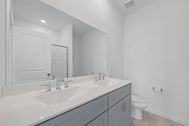 a bathroom with a double vanity sink and a mirror