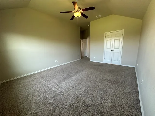 en empty room with windows and fan