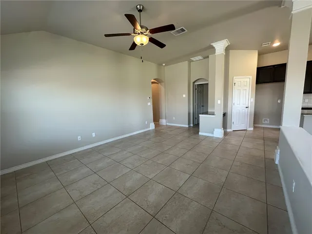 a view of a livingroom with a ceiling fan and window