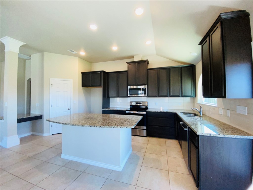 2270 Tallow Drive Portland, TX 78374 - Photo 5 of 38 a large kitchen with granite countertop a large counter top stainless steel appliances and cabinets