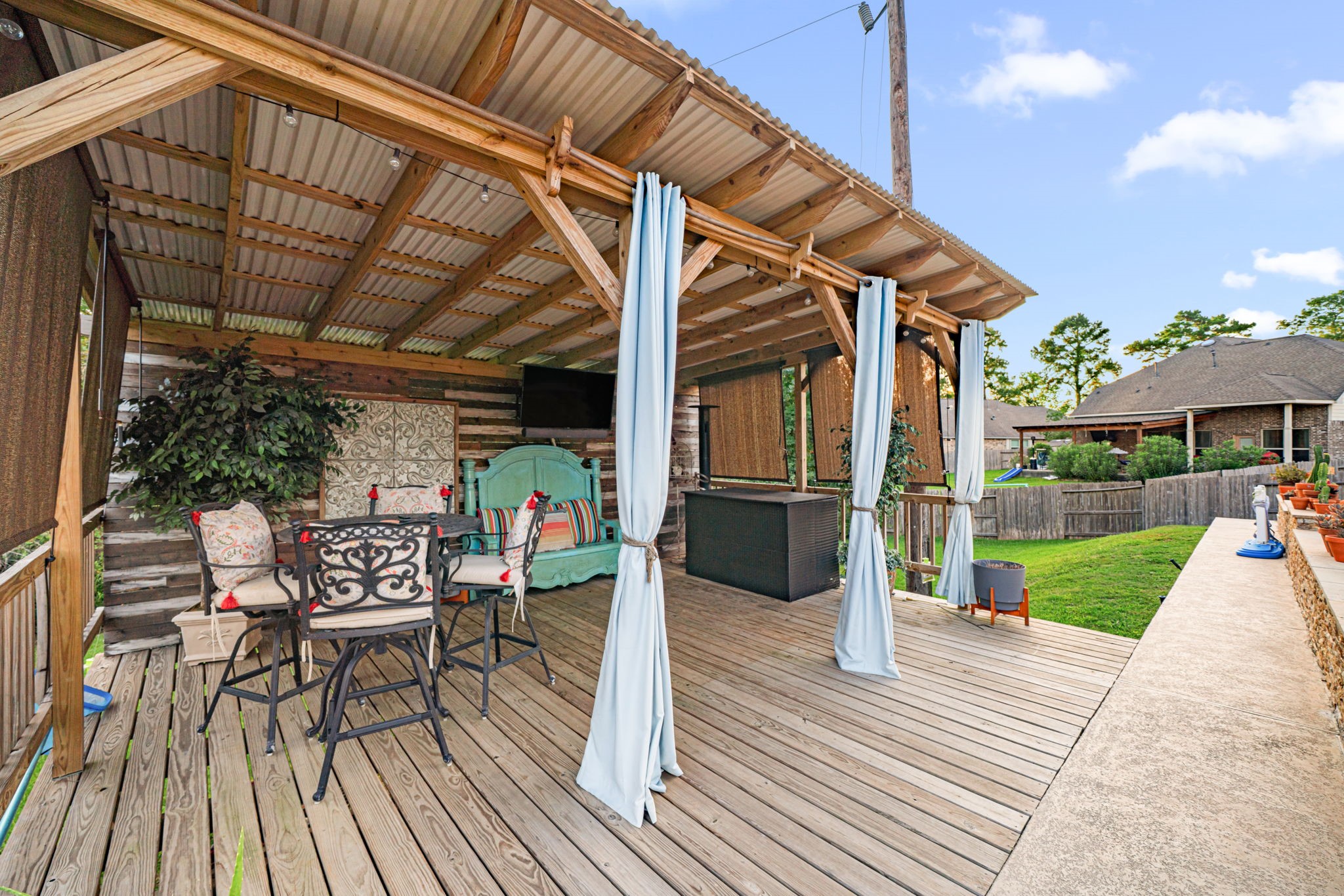 931 South Chamfer Way Crosby, TX 77532 - Photo 13 of 40 a view of a patio with table and chairs potted plants with wooden floor