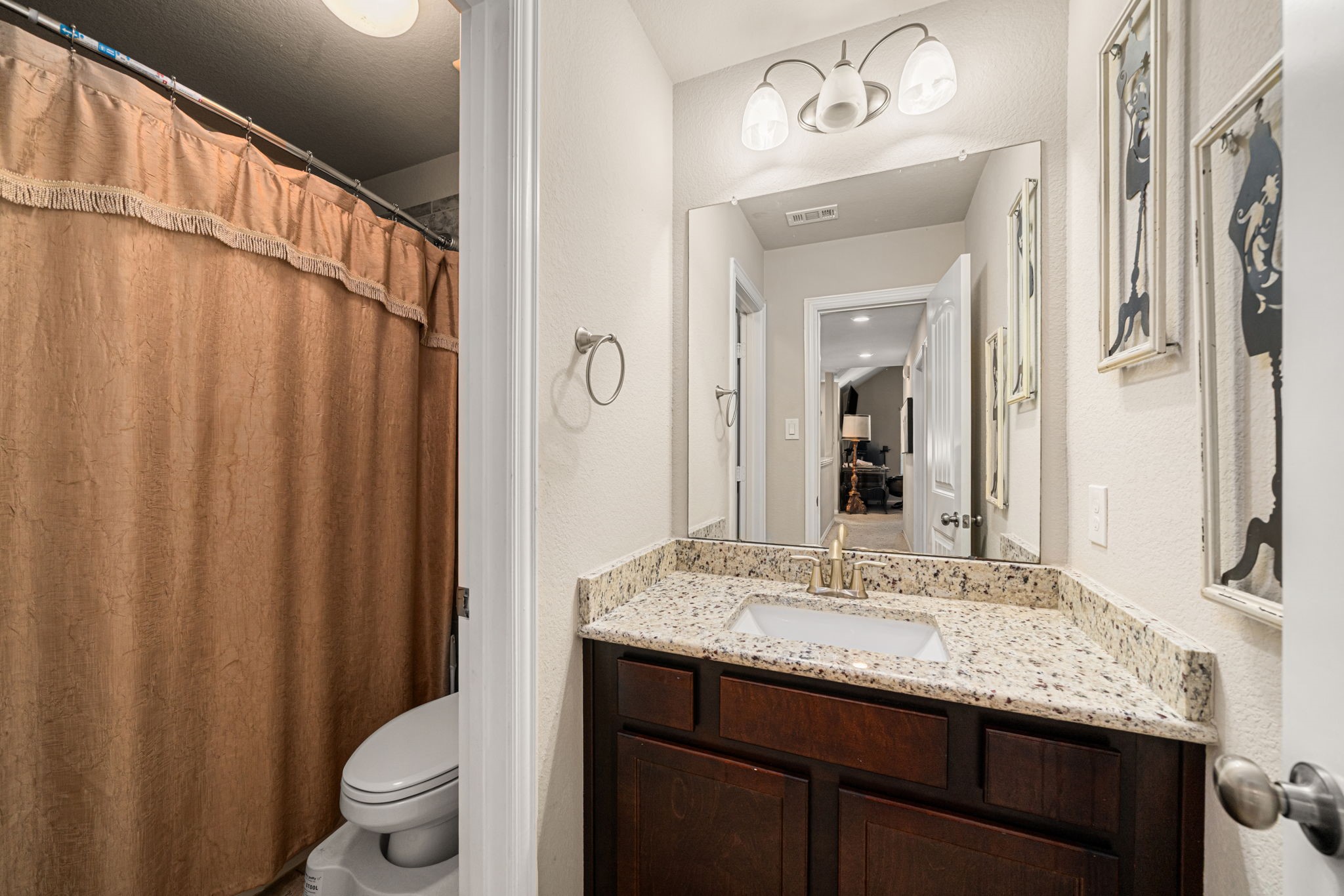 931 South Chamfer Way Crosby, TX 77532 - Photo 40 of 40 a bathroom with a granite countertop sink a toilet and a mirror