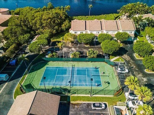 a view of a hallway with couches and chandelier