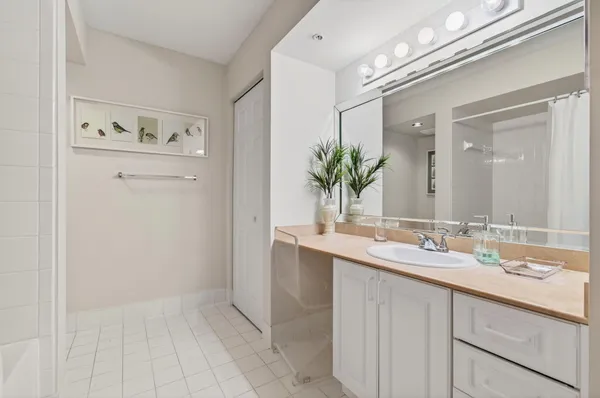 a en suite bathroom with a double vanity sink a mirror and a shower