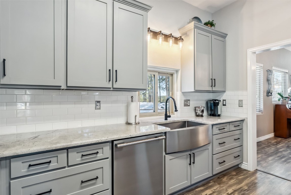109 Old Corral Road Bailey, CO 80421 - Photo 11 of 50 a kitchen with granite countertop a sink a stove and cabinets