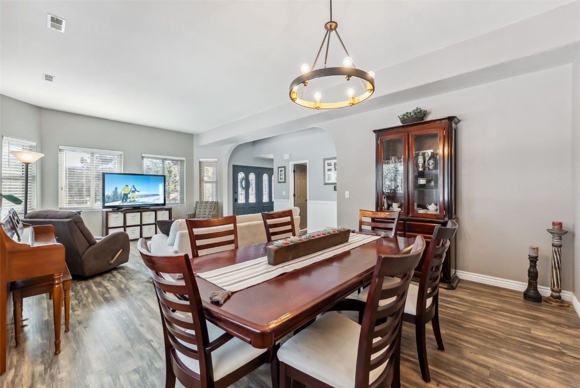 109 Old Corral Road Bailey, CO 80421 - Photo 15 of 50 a dining room with furniture a chandelier and wooden floor