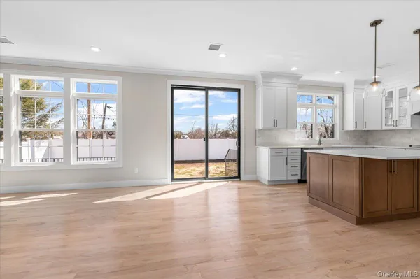 a view of an empty room with a window and fireplace