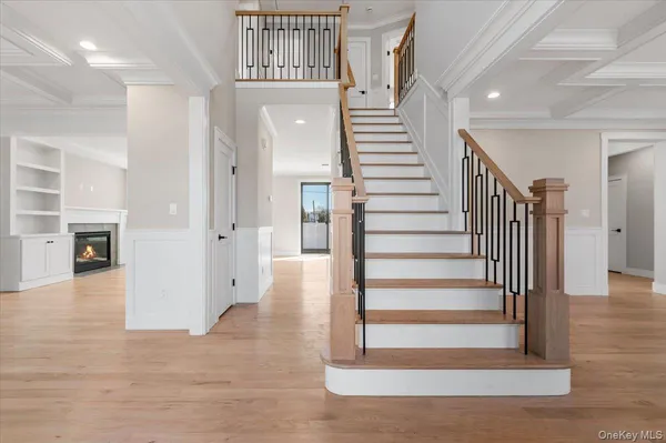 a view of entryway and hall with wooden floor