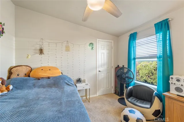 a kitchen with stainless steel appliances granite countertop a stove a refrigerator a kitchen island a dining table and chairs with wooden floor