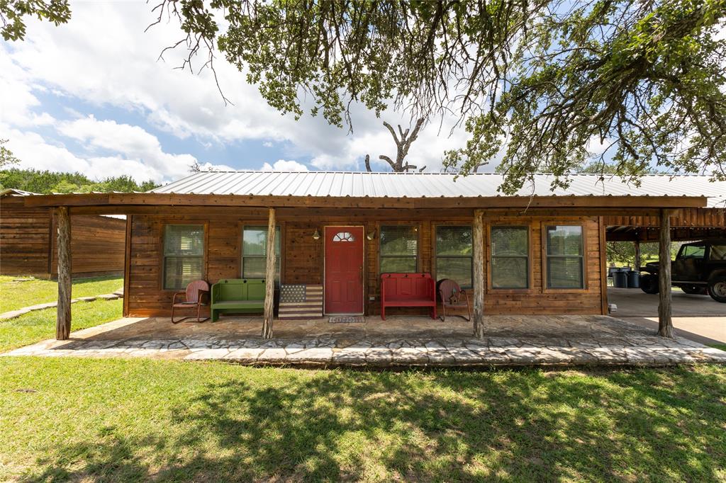 a view of a house with backyard porch and sitting area