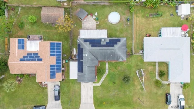 an aerial view of a house with a swimming pool