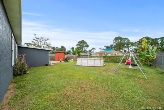 a backyard of a house with table and chairs