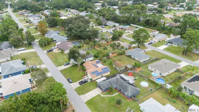 an aerial view of residential houses with outdoor space