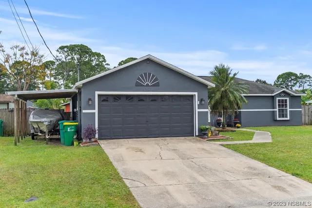 a front view of house with yard and green space