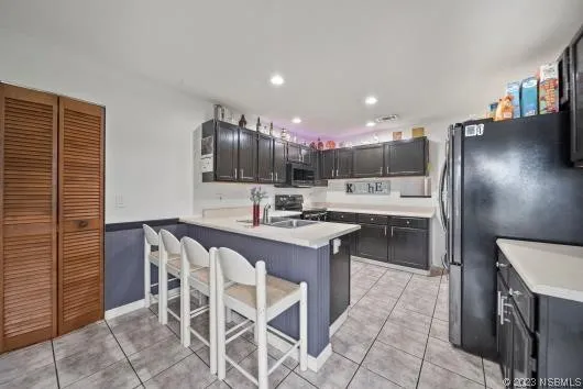 a kitchen with a sink cabinets and stainless steel appliances