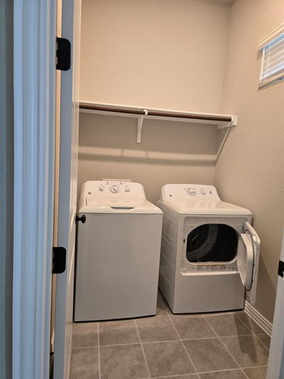 4907 Escape Rivera Drive Austin, TX 78747 - Photo 16 of 28 Functional laundry room featuring a shelf, washer, and dryer.